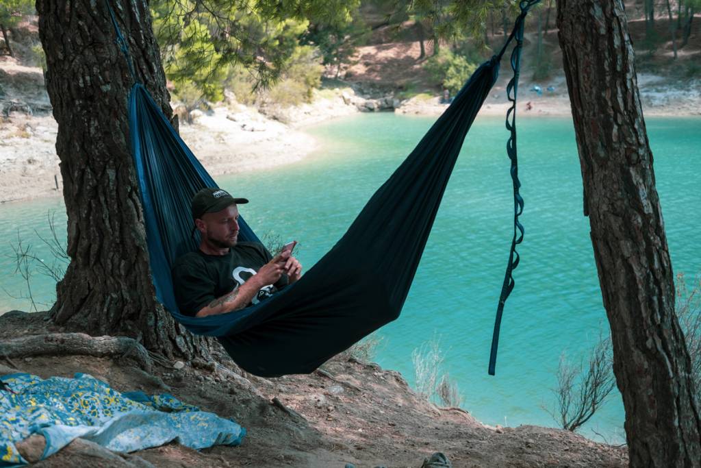 Relaxing in a hammock above the turquoise water of Ardales Lake