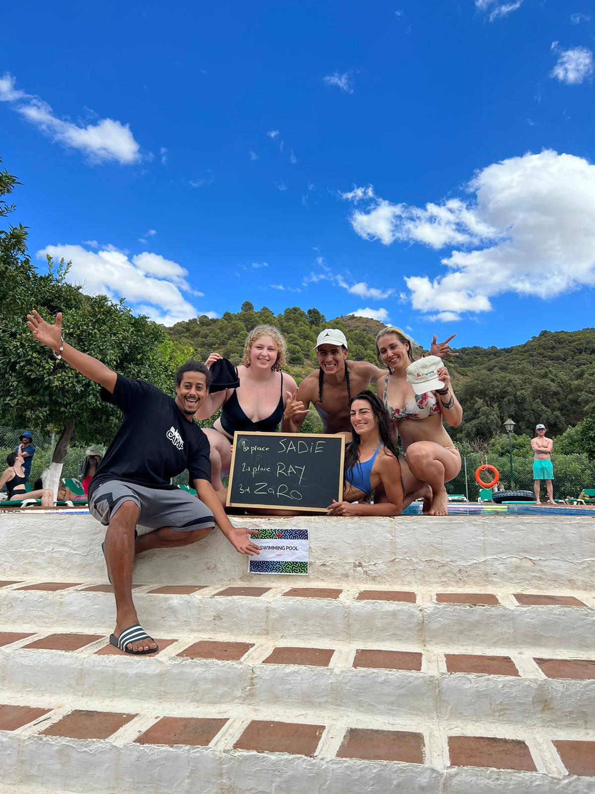 Campers waving by the pool at La Granja