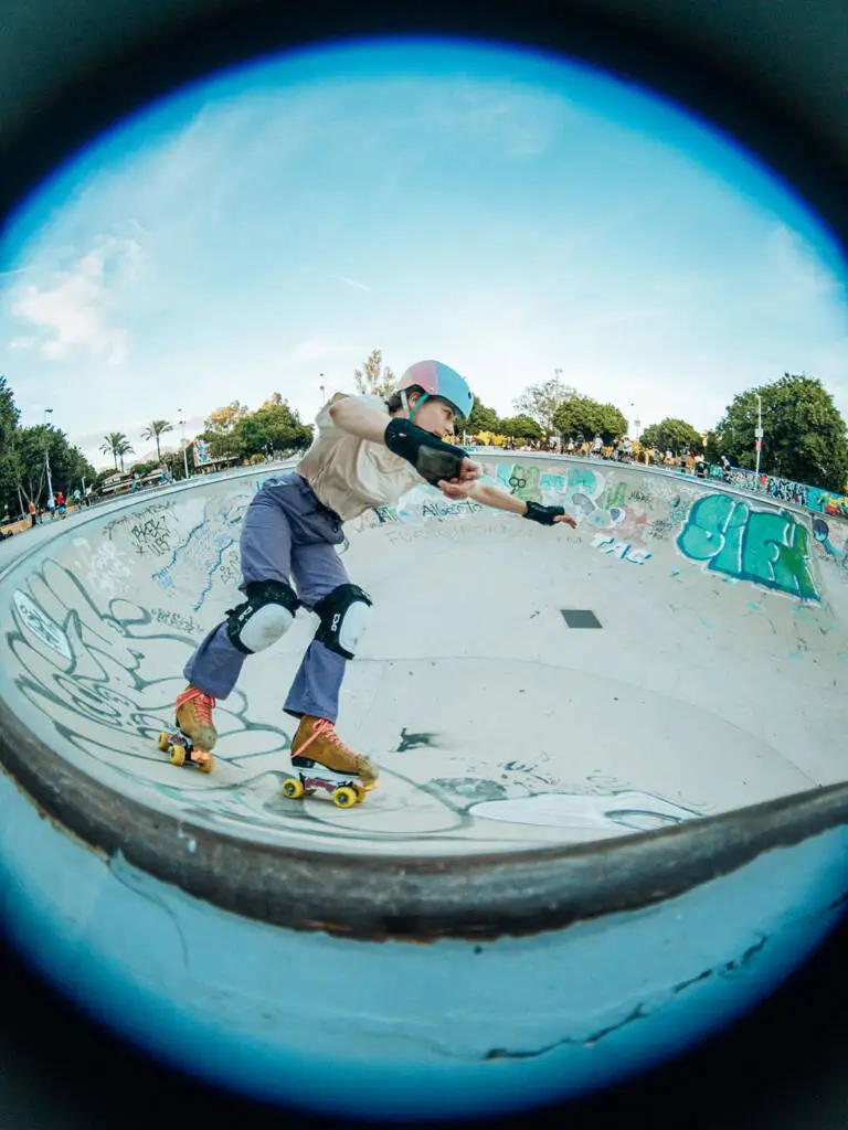 A quad skater dropping into a bowl