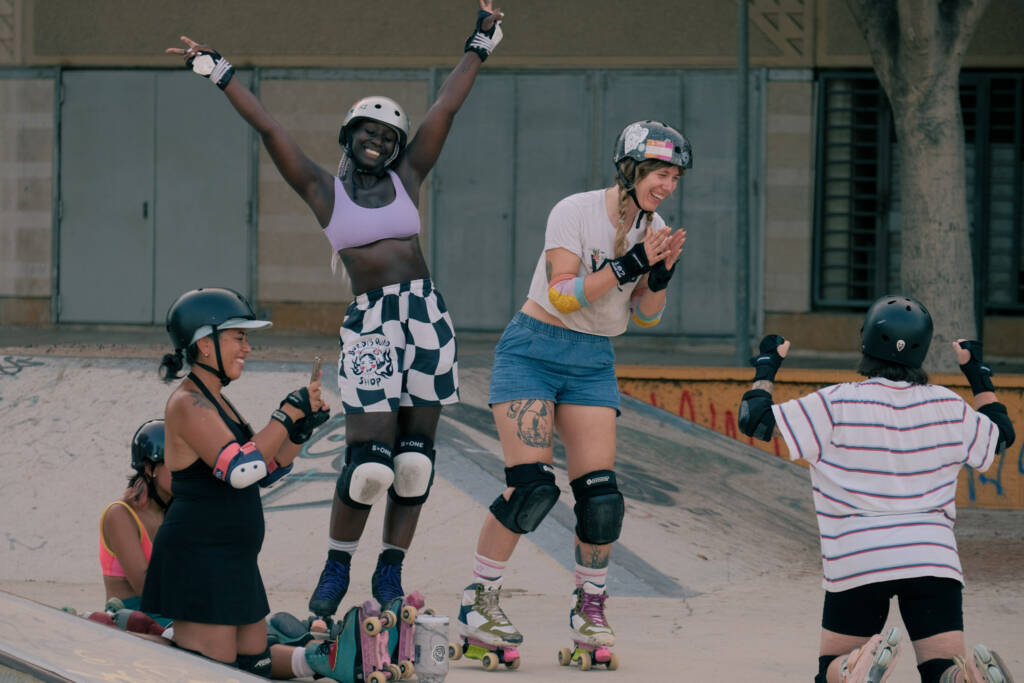 Quad skaters cheering and celebrating together on the ramp