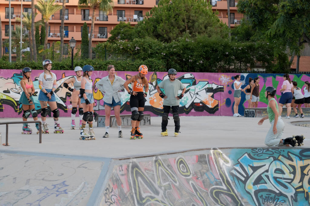 Group of quad and inline skaters lined up for a lesson at the bowl